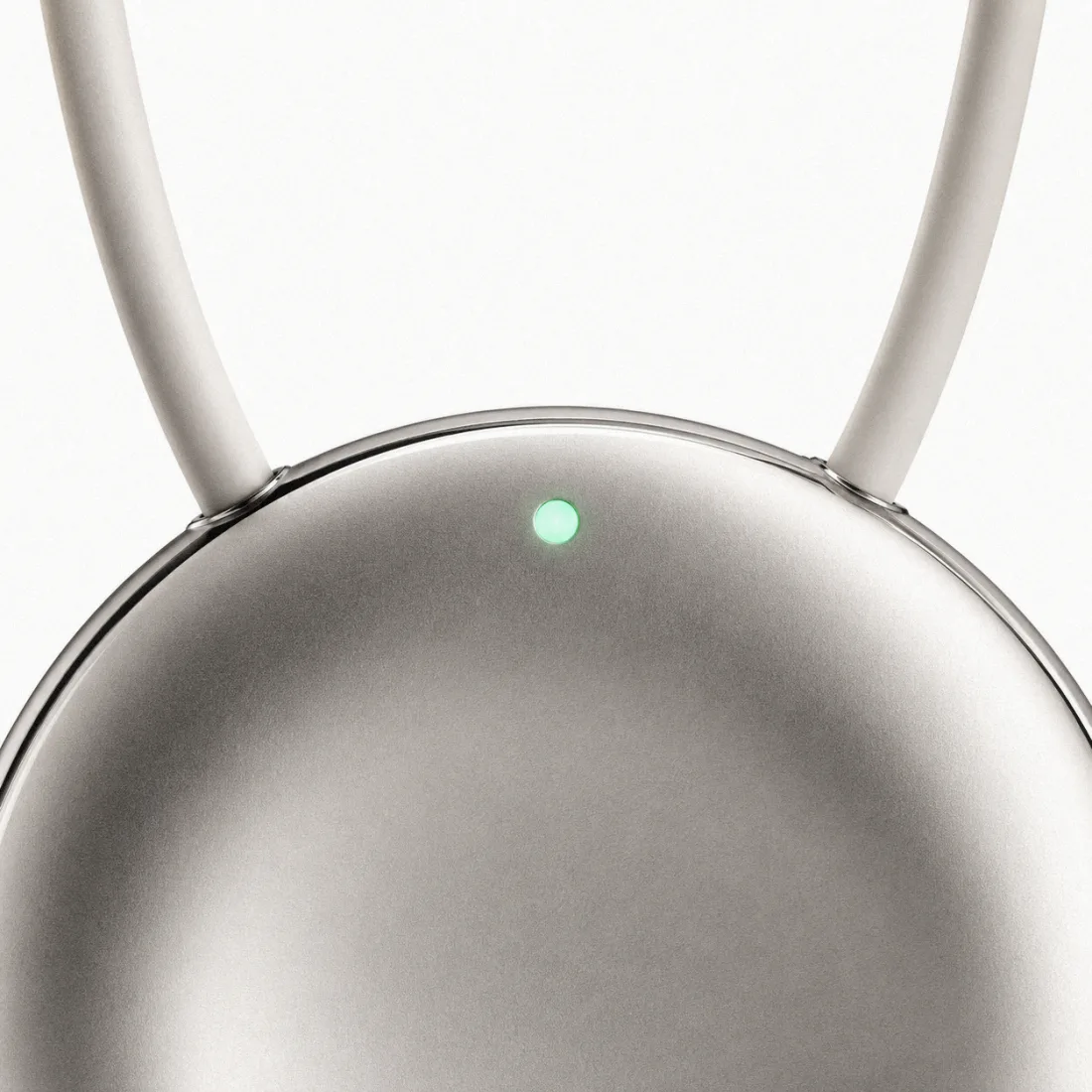 Close-up of the Pebb pendant: brushed solid metal with a single soft status light